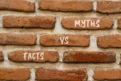 Facts vs myths symbol. Concept words Facts vs myths on red bricks on a beautiful brick wall background. Business, finacial and facts vs myths concept. Copy space.
