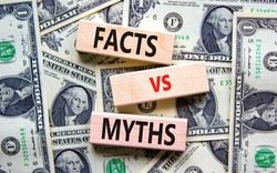 Facts vs myths symbol. Concept words Facts vs myths on wooden blocks on a beautiful background from dollar bills. Business, finacial and facts vs myths concept. Copy space.