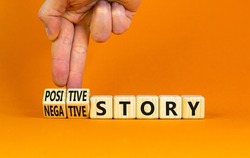 Positive or negative story symbol. Businessman turns cubes, changes concept words Negative story to Positive story. Beautiful orange background. Business positive negative story concept. Copy space.