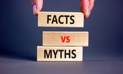 Facts vs myths symbol. Concept words Facts vs myths on wooden blocks on a beautiful grey table grey background. Businessman hand. Business, finacial and facts vs myths concept. Copy space.