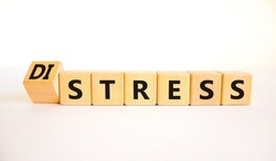 Distress or stress symbol. Turned the wooden cube and changed the concept word Distress to Stress. Beautiful white table white background, copy space. Psychlogical and stress or distress concept.