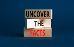 Uncover the facts symbol. Concept words Uncover the facts on wooden blocks on a beautiful grey table grey background. Business and uncover the facts concept. Copy space.