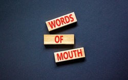 Words of mouth symbol. Concept words Words of mouth on wooden blocks on a beautiful black table black background. Business, finacial and words of mouth concept. Copy space.