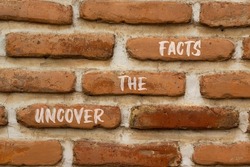 Uncover the facts symbol. Concept words Uncover the facts on red bricks on a beautiful brick wall background. Business and uncover the facts concept. Copy space.