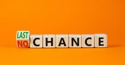 No or last chance symbol. Turned wooden cubes and changed concept words No chance to Last chance. Beautiful orange table orange background, copy space. Business and no or last chance concept.