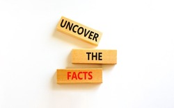 Uncover the facts symbol. Concept words Uncover the facts on wooden blocks on a beautiful white table white background. Business and uncover the facts concept. Copy space.