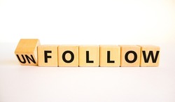 Follow or unfollow symbol. Turned wooden cubes and changed concept words Follow to Unfollow. Beautiful white table white background. Business and follow or unfollow concept. Copy space.