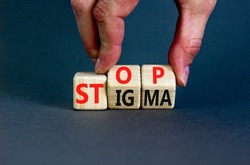 Stop stigma symbol. Concept words Stop stigma on wooden cubes. Businessman hand. Beautiful grey table grey background. Business and Stop stigma concept. Copy space.