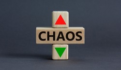 Time to chaos symbol. A wooden cubes with up icon. Wooden cubes with the concept word Chaos. Beautiful grey table grey background. Business and chaos concept. Copy space.