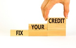 Fix your credit symbol. Concept words Fix your credit on wooden blocks on a beautiful white table white background. Businessman hand. Business, finacial and fix your credit concept. Copy space.