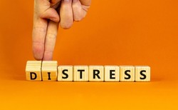 Stress or distress symbol. Psychologist turns cubes and changes the concept word Stress to Distress. Beautiful orange table orange background, copy space. Psychlogical distress or stress concept.