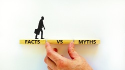 Facts vs myths symbol. Concept words Facts vs myths on wooden blocks on a beautiful white table white background. Businessman hand. Business, finacial and facts vs myths concept. Copy space.