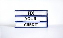 Fix your credit symbol. Concept words Fix your credit on books on a beautiful white table white background. Business, finacial and fix your credit concept. Copy space.