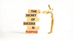 Success and purpose symbol. Wooden blocks with concept words The secret of success is purpose. Beautiful white background, copy space. Businessman model. Business, success and purpose concept.