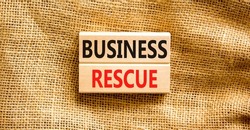 Business rescue symbol. Concept words Business rescue on wooden blocks on a beautiful canvas table canvas background. Businessman hand. Business rescue and support concept. Copy space.