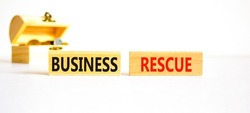 Business rescue symbol. Concept words Business rescue on wooden blocks on a beautiful white table white background. Wooden chest with coins. Business rescue and support concept. Copy space.