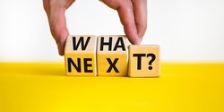 What next symbol. Concept words What next on wooden blocks. Businessman hand changes words what to next. Beautiful yellow table white background. Business What next concept. Copy space.