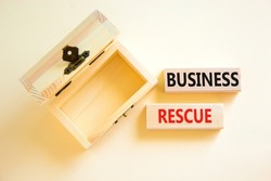 Business rescue symbol. Concept words Business rescue on wooden blocks on a beautiful white table white background. Empty wooden chest. Business rescue and support concept. Copy space.