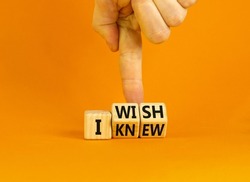 I knew or wish symbol. Concept words I knew and I wish on wooden cubes. Businessman hand. Beautiful orange table orange background. Business and I knew or wish concept. Copy space.