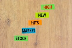 Stock market hits new high symbol. Concept words Stock market hits new high on color papers on a beautiful wooden background. Business and stock market hits new high concept. Copy space.