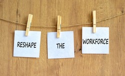 Reshape the workforce and support symbol. Concept words Reshape the workforce on white paper on clothespins. Beautiful wooden background. Business and reshape the workforce quote concept. Copy space