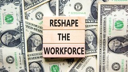 Reshape the workforce support symbol. Concept words Reshape the workforce on wooden blocks on dollar bills. Beautiful background from dollar bills. Business reshape the workforce concept. Copy space