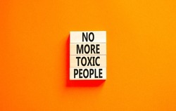 No more toxic people symbol. Concept words No more toxic people on wooden blocks on a beautiful orange table orange background. Business, psychological no more toxic people concept.