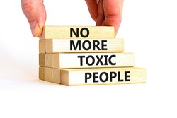 No more toxic people symbol. Concept words No more toxic people on wooden blocks on a beautiful white table white background. Psychologist hand. Business, psychological no more toxic people concept.