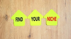 Find your niche symbol. Concept words Find your niche on green papers on papers on wooden clothespins. Beautiful wooden background. Business and find your niche concept. Copy space.