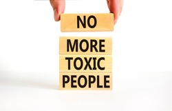 No more toxic people symbol. Concept words No more toxic people on wooden blocks on a beautiful white table white background. Psychologist hand. Business, psychological no more toxic people concept.