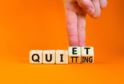 Quiet quitting symbol. Concept words Quiet quitting on wooden cubes. Businessman hand. Beautiful orange table orange background. Business quiet quitting concept. Copy space.