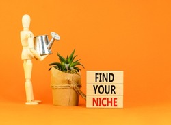 Find your niche symbol. Concept words Find your niche on wooden blocks. Businessman model. Beautiful orange table orange background. Business and find your niche concept. Copy space.