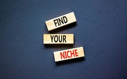 Find your niche symbol. Concept words Find your niche on wooden blocks. Beautiful grey table grey background. Business and find your niche concept. Copy space.