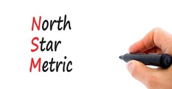 NSM north star metric symbol. Concept words NSM north star metric on white paper on a beautiful white background. Businessman hand. Business and NSM north star metric concept. Copy space.