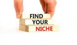 Find your niche symbol. Concept words Find your niche on wooden blocks. Businessman hand. Beautiful white table white background. Business and find your niche concept. Copy space.