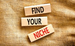 Find your niche symbol. Concept words Find your niche on wooden blocks. Beautiful canvas table canvas background. Business and find your niche concept. Copy space.