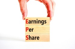 EPS earnings per share symbol. Concept words EPS earnings per share on wooden blocks on a beautiful white background. Businessman hand. Business and EPS earnings per share concept. Copy space.