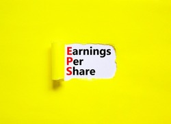 EPS earnings per share symbol. Concept words EPS earnings per share on white paper on a beautiful yellow background. Business and EPS earnings per share concept. Copy space.