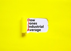 DJIA Dow Jones industrial average symbol. Concept words DJIA Dow Jones industrial average on white paper on beautiful yellow background. Business DJIA Dow Jones industrial average concept. Copy space