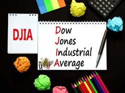 DJIA Dow Jones industrial average symbol. Concept words DJIA Dow Jones industrial average on white note on beautiful black background. Business DJIA Dow Jones industrial average concept. Copy space