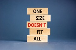 One size does not fit all symbol. Concept words One size does not fit all on wooden blocks. Beautiful grey table grey background. One size does not fit all business concept. Copy space.