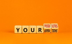 Your aspirations or possibilities symbol. Concept words Your aspirations or possibilities on wooden cubes. Beautiful orange background. Business Your aspirations or possibilities concept. Copy space.