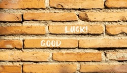 Good luck symbol. Concept words Good luck on beautiful brown bricks. Beautiful brick wall background. Beautiful brick wall. Business, motivational good luck concept. Copy space.