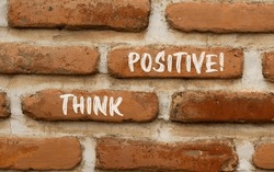 Think positive symbol. Concept words Think positive on beautiful brown bricks. Beautiful brick wall background. Beautiful brick wall. Business motivational think positive thinking concept. Copy space.
