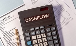 CASHFLOW word on calculator and pen on documents
