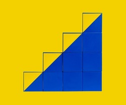 Cubes in stairs form. Professional development and growth, success and progress concept. Career ladder from yellow and blue blocks. High quality photo