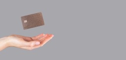 Hand and levitating credit card mock up on banner, background with copy space for text.