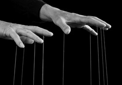 Man hands with strings on fingers. Dominator, abuser using power to make person feel humiliated. Manipulation, negative influence concept. Black and white. High quality photo