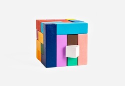 Wooden puzzle cube from different geometric elements. Kids or family toy for intelligence, logical thinking, creativity development, concentration improvement. Conundrum. High quality photo