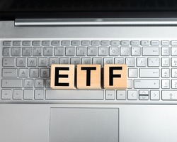 ETF investing fund. Acronym through magnifying glass. High quality photo